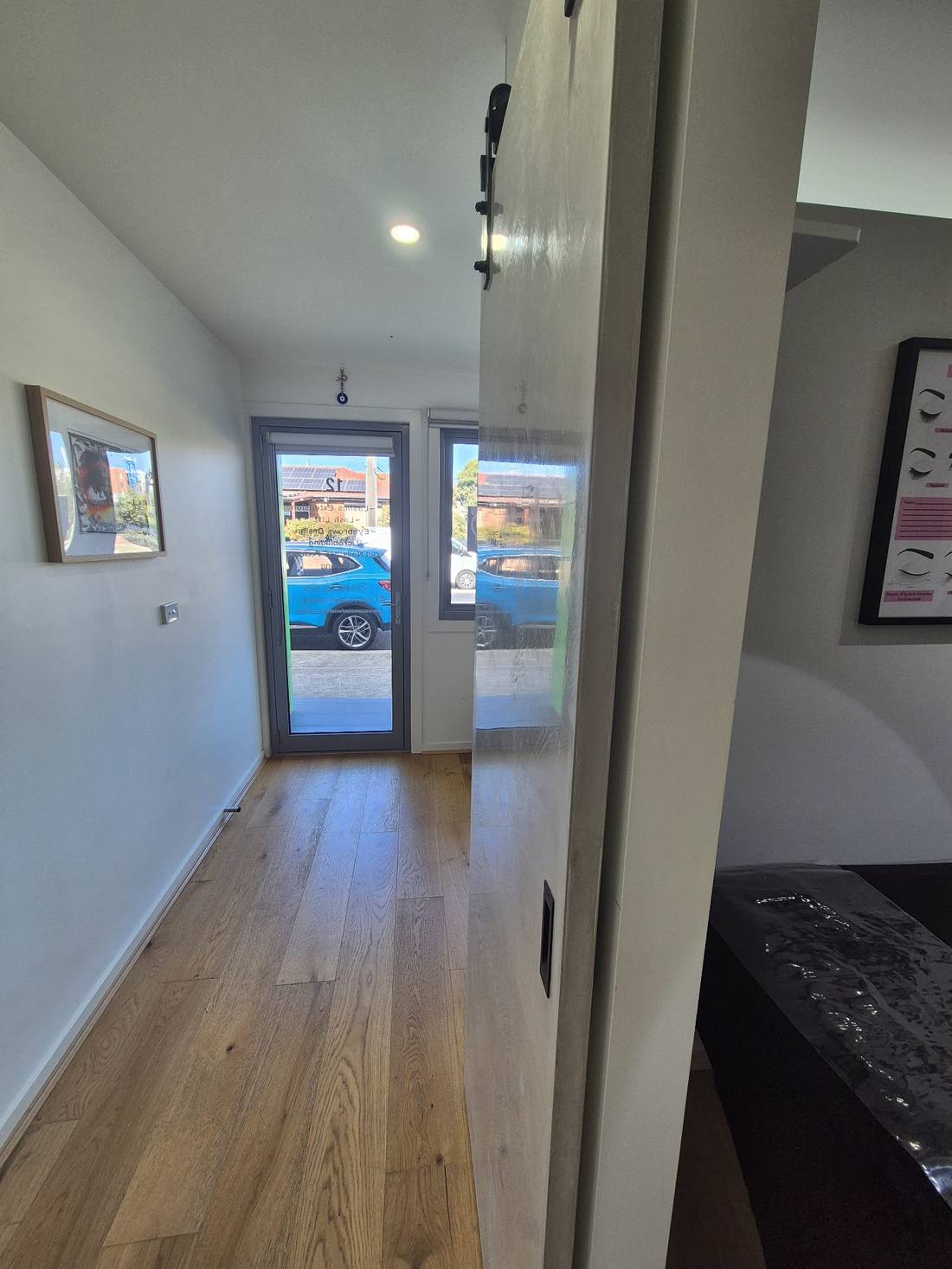 Repainted interior hallway with hung artwork and timber floors