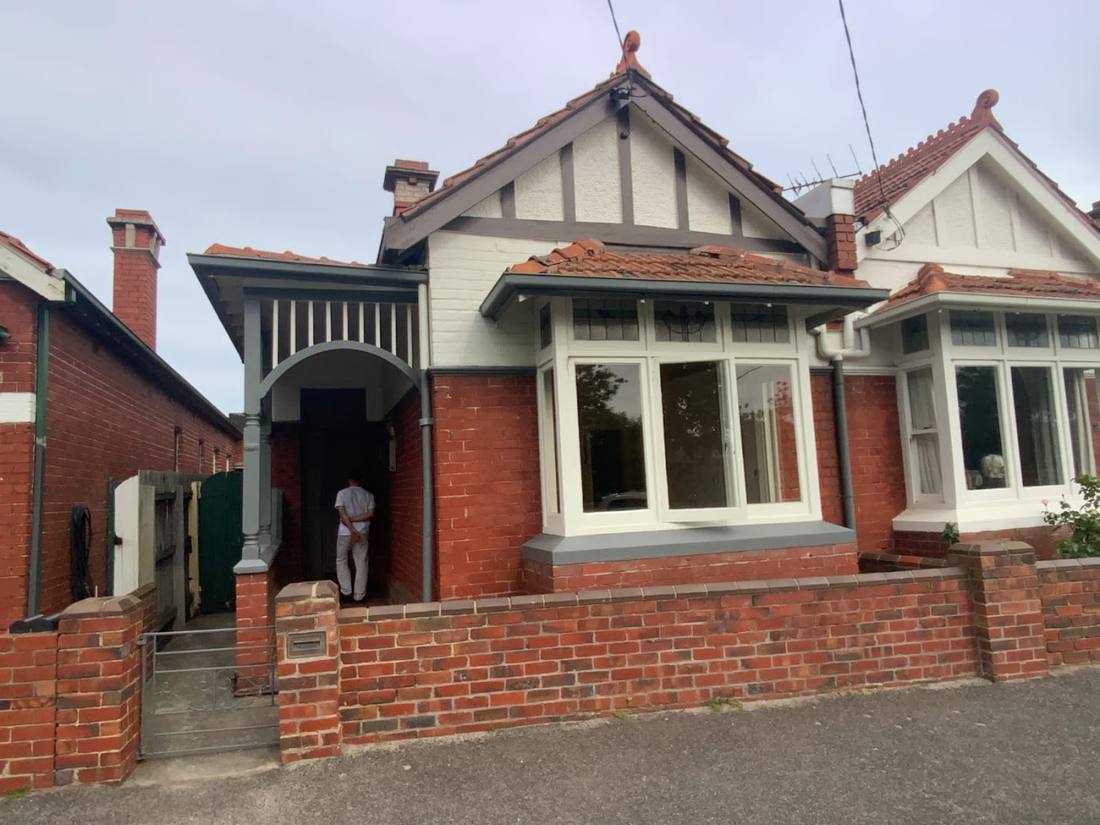 Red brick heritage home repainted in Carlton
