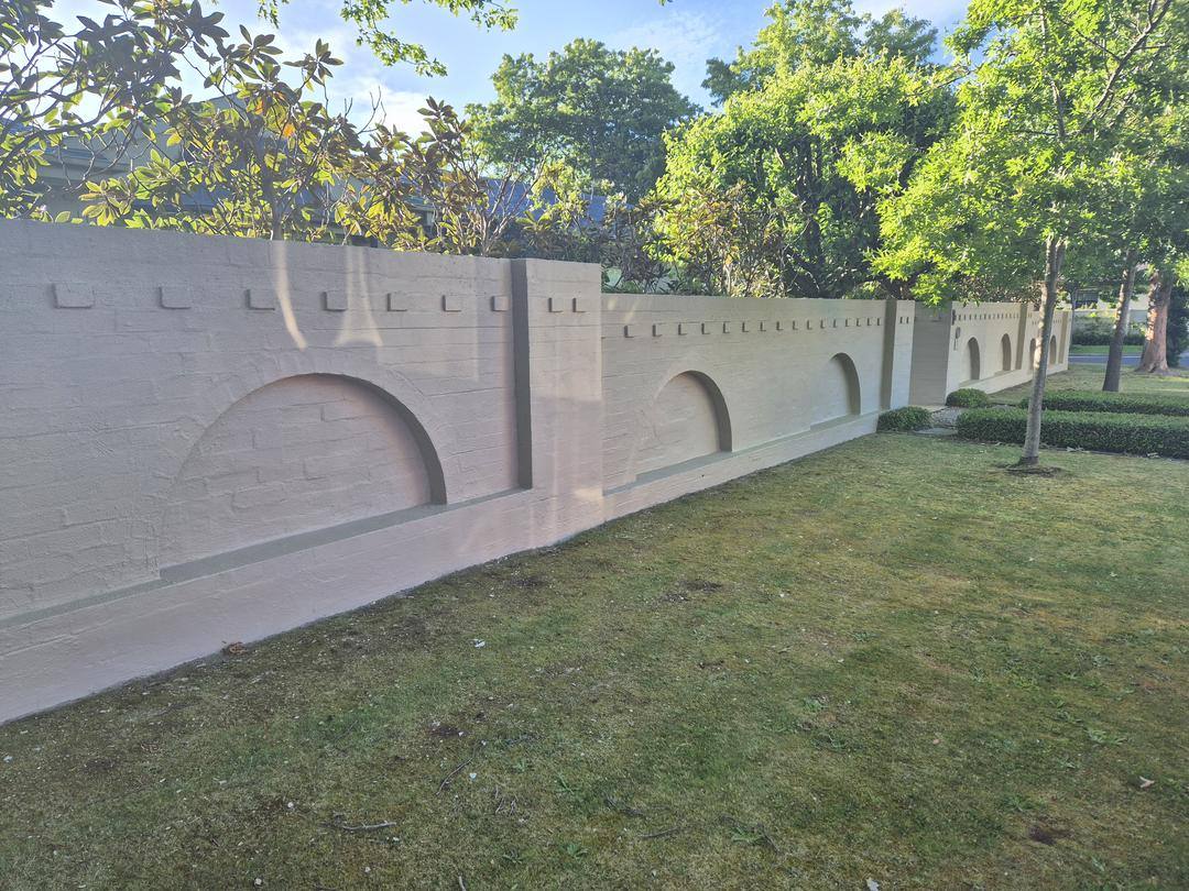 Decorative textured render feature wall with arched recesses
